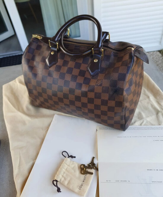 lv speedy bag on table