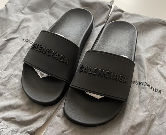 Close-up of a Balenciaga slides dupe, showcasing the detailed embossed logo