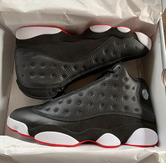 Unboxing a fresh pair of Jordan 13 reps, capturing the excitement of adding a new addition to a sneaker collection