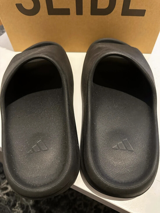 Fashion-forward Yeezy Slides Replica Sandals in black, mirroring the original design
